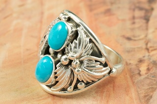 Genuine Sleeping Beauty Turquoise set in Sterling Silver. Sterling Silver Wolf and Leaf Design. The Sleeping Beauty Turquoise mine is located in Gila County, Arizona. Created by Navajo Artist Freddy Charley. Signed. 
